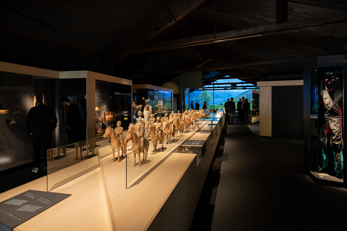 Comparison image showing the concept rendering from the competition phase and a photo of the finished exhibition space.